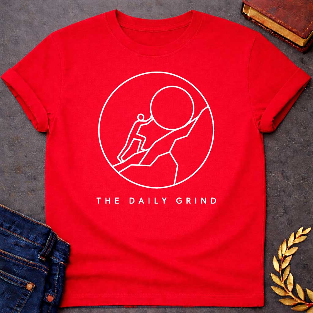Red T-Shirt with a minimalist white graphic design.  Inside a thin circle is a simple line-art illustration of a stick figure pushing a large boulder up a steep hill, representing the myth of Sisyphus. Below the circle, the text reads "THE DAILY GRIND" in a clean, sans-serif font.