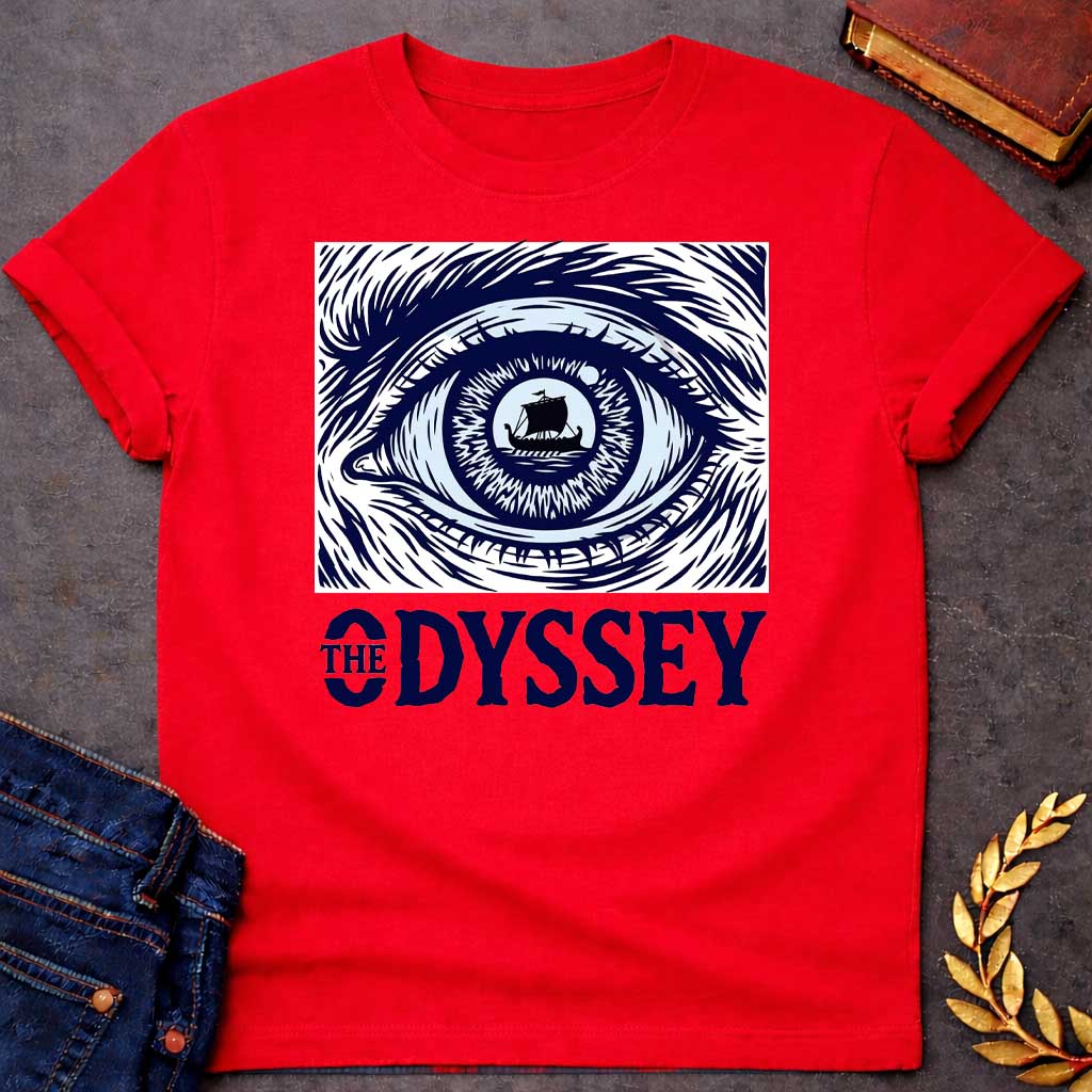 Red T-Shirt with a dramatic graphic design for 'The Odyssey' featuring a stylized eye in navy blue and white. The iris contains a silhouette of an ancient Greek ship with a single sail, surrounded by radiating lines suggesting both an iris pattern and oceanic waves. Swirling, turbulent linework evokes stormy seas and Odysseus's tumultuous journey. Bold serif text reads 'THE ODYSSEY' in navy blue. Combines classical maritime imagery with modern design, emphasizing vision, journey, destiny, and fate.