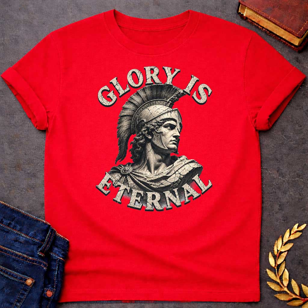 Red T-Shirt with a classical illustration of a Greek warrior in profile, rendered in sepia tones with weathered, cracked texture. The figure wears an ornate Corinthian helmet with black horsehair crest, long curly hair, and armor with a draped cloak. The warrior gazes stoically with classical features. Distressed serif letters spell 'GLORY IS' above and 'ETERNAL' below. The design has a vintage, monumental quality reminiscent of ancient statuary, emphasizing themes of heroism, honor, and timeless legacy.