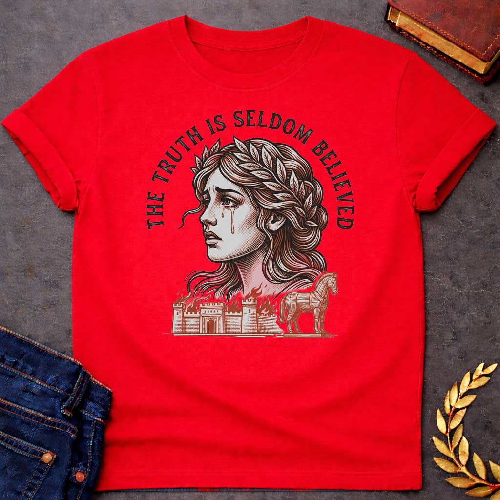 Red T-shirt with a A Greek mythology design featuring a detailed woodblock-engraving style illustration of a crying Cassandra in profile. She wears a laurel wreath, with tears streaming down her face. Arched above her is the text "THE TRUTH IS SELDOM BELIEVED" in a bold black serif font. Below her portrait, a burning ancient city wall and the Trojan Horse are illustrated in a fine-line, terracotta-orange style.