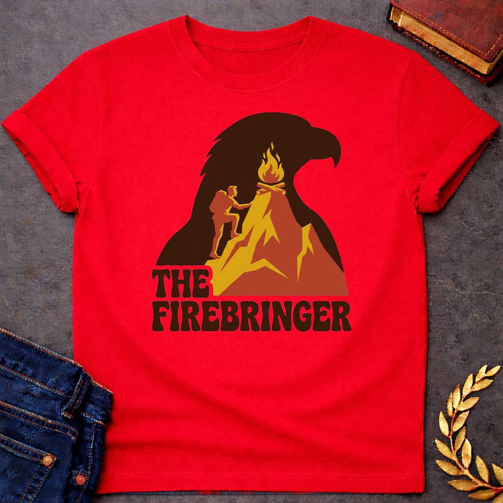 Red T-shirt with a retro, outdoor-style t-shirt graphic referencing Prometheus. It features a silhouette of a hiker with a backpack climbing an orange and yellow mountain peak toward a campfire at the top. The entire mountain scene is set against a large background silhouette of an eagle's head in dark brown. Below the image, the text "THE FIREBRINGER" is written in a bold, stylized 1970s-style brown font.
