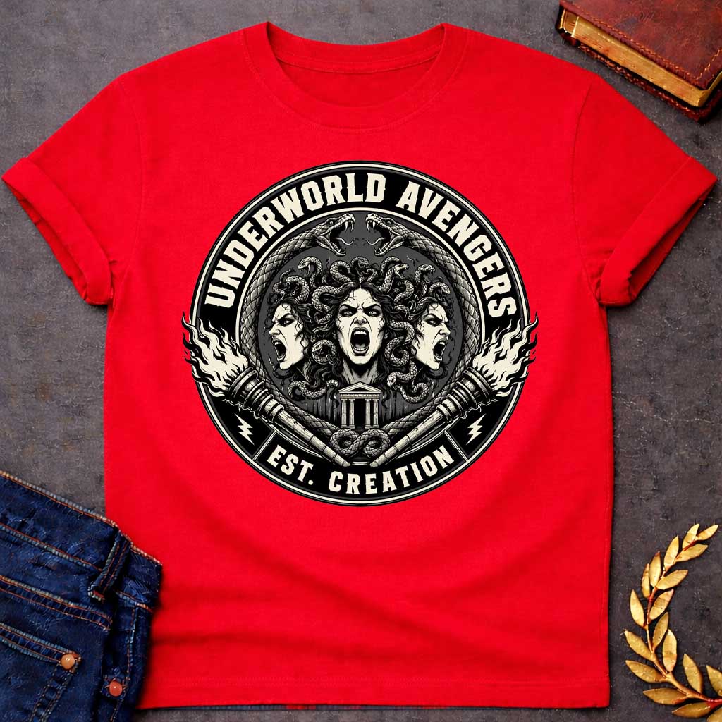 Red T-shirt with an Official emblem design for the 'Underworld Avengers,' a parody combining Greek mythology with Marvel. Three Fury faces with detailed serpent hair display aggressive expressions. A Greek temple sits below, framed by crossed ornate daggers. Flames and lightning bolts accent the circular seal in vintage badge style. Text reads 'Underworld Avengers: Est. Creation.' Black and cream colors celebrate a team of divine vengeance and supernatural justice.