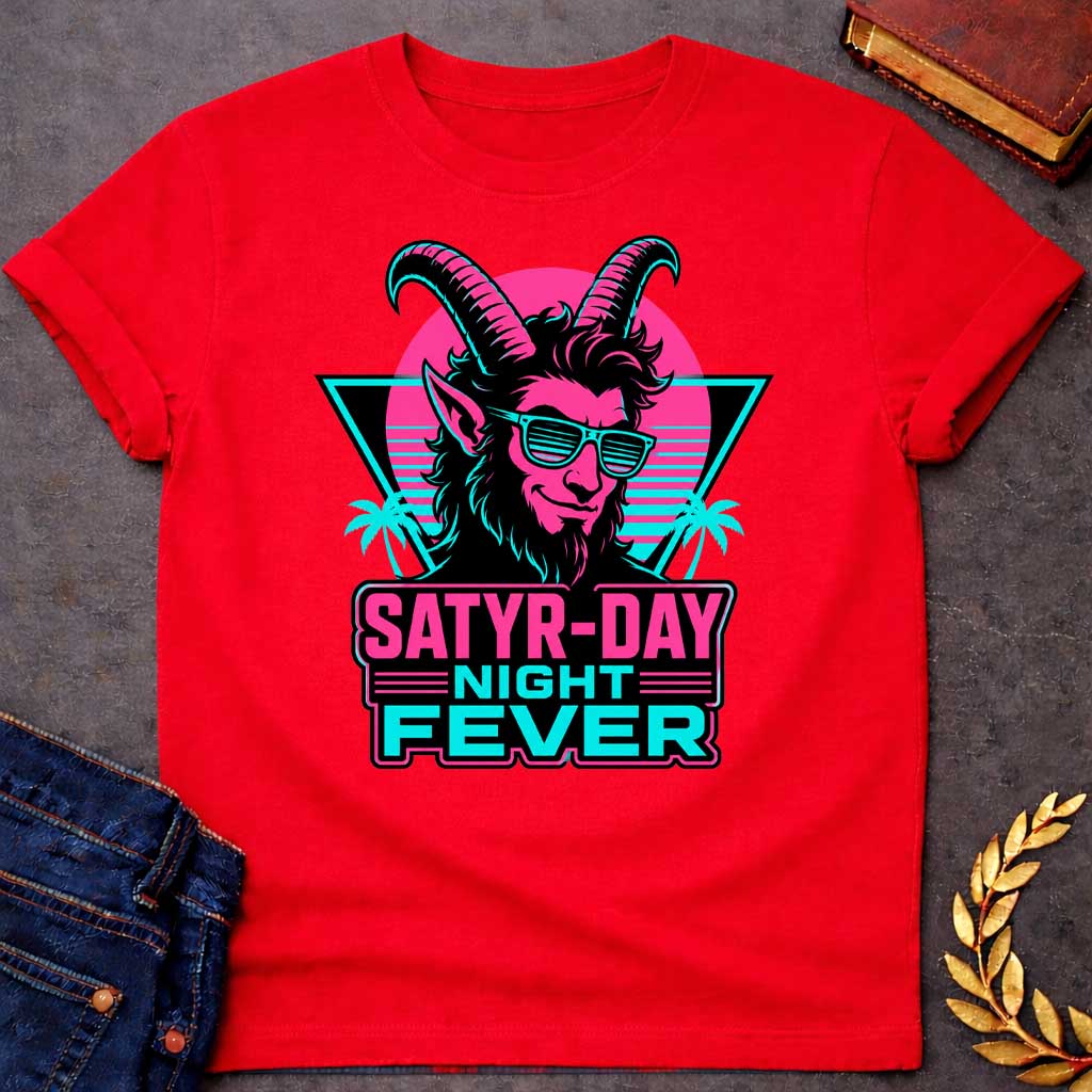 Red T-shirt with a vibrant 1980s synthwave-style graphic for "satry-day night fever.jpg". It features a cool satyr with large horns, a smirk, and cyan shutter shades, illuminated in neon pink and black. The background shows a retrowave sunset grid, a black triangle, and palm trees. Below, the punny title "SATYR-DAY NIGHT FEVER" is displayed in bold neon pink and cyan block lettering against a dark badge