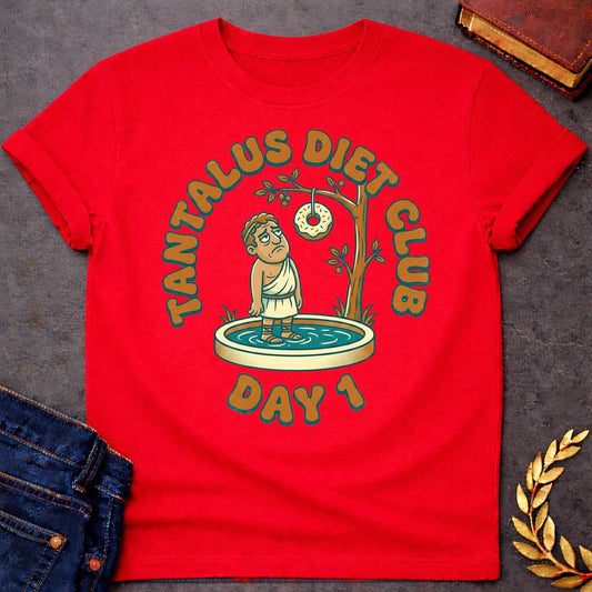 Red t-shirt with A cartoon illustration, Standing in a small shallow pool next to a tree, a sad Greek man in a toga gazes glumly at a frosted donut with sprinkles dangling just out of reach from a branch. Chunky, retro orange and teal text arches over the graphic reading "TANTALUS DIET CLUB", with "DAY 1" featured prominently at the bottom.