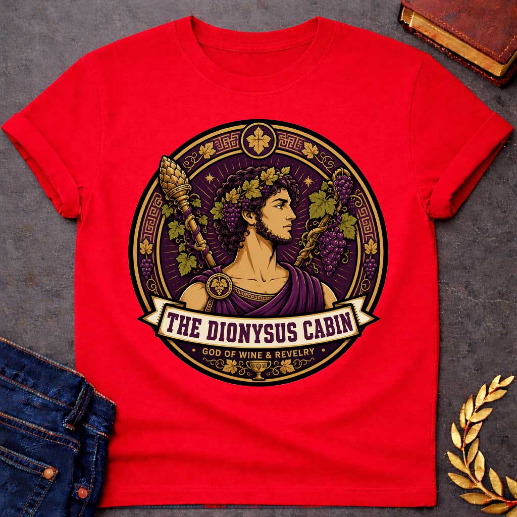 Red t-shirt with a Dionysus Greek mythology cabin design featuring the god of wine and revelry wearing a grapevine crown and purple robes, surrounded by clusters of grapes, vine leaves, a thyrsus, Greek key patterns, and a wine cup. Purple and gold circular emblem includes the text “The Dionysus Cabin” and “God of Wine & Revelry,”