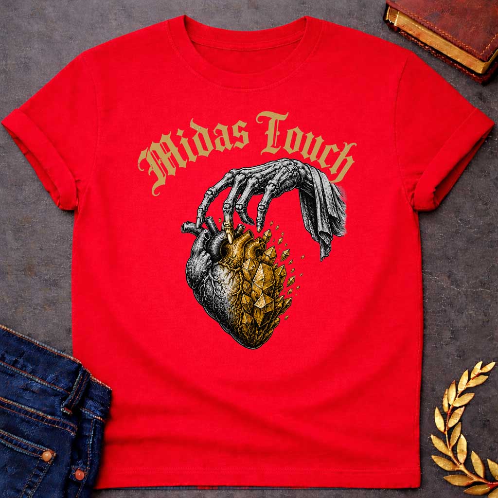Red t-shirt with A Vintage engraving-style Greek mythology design featuring a skeletal hand with the Midas touch transforming half of an anatomical heart into shimmering gold crystals. Above the illustration, gothic lettering reads "Midas Touch." Inspired by the tragic King Midas myth, the design symbolizes how greed and the pursuit of wealth can harden the heart, using bold black and metallic gold artwork.
