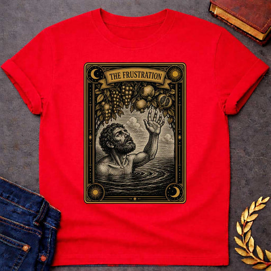 Red t-shirt with A detailed tarot card-style illustration. Set within an ornate black and gold border featuring sun and moon corner emblems, a bearded man in rippling water reaches one hand up toward hanging branches overflowing with grapes and pomegranates. A ribbon banner across the top of the card displays the title "THE FRUSTRATION" in a bold serif typeface.
