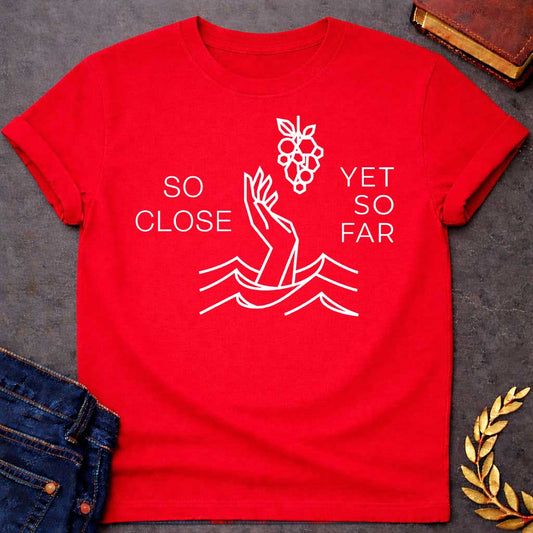 Red t-shirt with A minimalist, geometric line-art design. Rendered in crisp white lines, a stylized hand reaches out from geometric water waves toward a cluster of grapes hanging above it. Simple, thin sans-serif text flanks the central illustration, with "SO CLOSE" stacked on the left and "YET SO FAR" stacked on the right.
