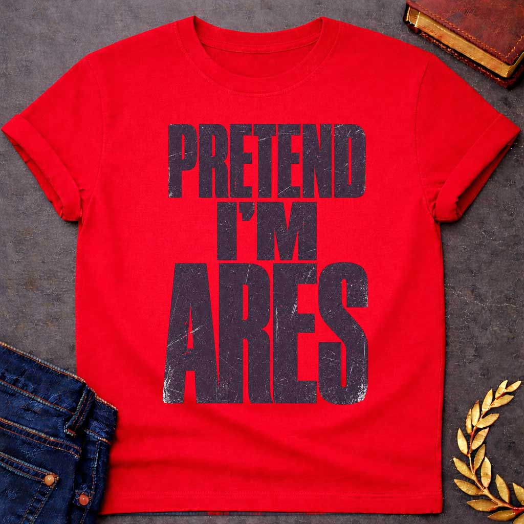 Red t-shirt with a Pretend I’m Ares Greek mythology design featuring bold distressed purple typography on a transparent background. The stacked text reads “PRETEND I’M ARES” in a rugged vintage block font, creating a humorous Greek god design inspired by Ares, the god of war, courage, battle, and martial strength.