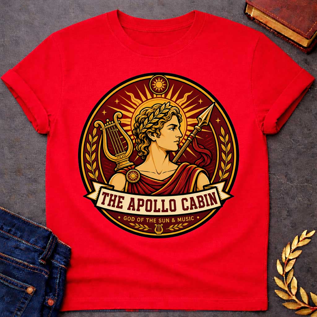 Red t-shirt with a Apollo Greek mythology cabin design featuring the god of the sun and music wearing a golden laurel crown, framed by a radiant sun, lyre, spear, stars, and laurel branches. Rich red, gold, and cream circular camp-style emblem includes the text “The Apollo Cabin” and “God of the Sun & Music.