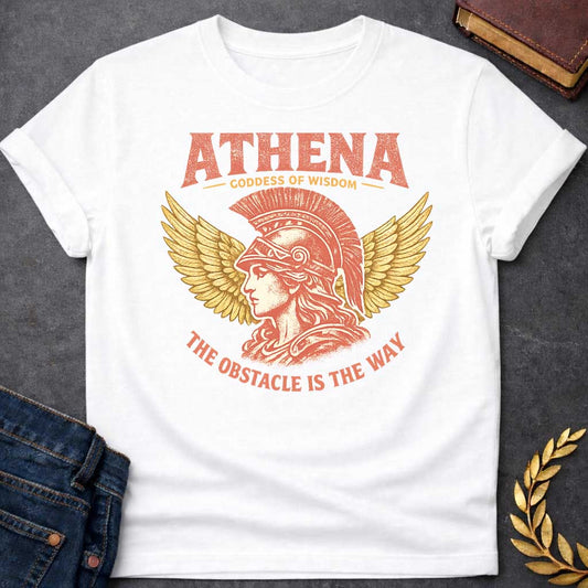 White t-shirt graphic featuring a side-profile illustration of Athena wearing a Corinthian helmet with a red plume, flanked by large golden wings. Text reads "ATHENA – Goddess of Wisdom" arched above and "The Obstacle Is the Way" curved below, in a vintage Greek mythology style with rose and gold tones