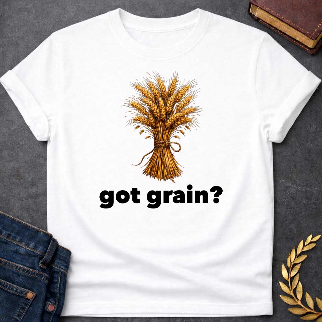 White T-shirt graphic featuring a detailed realistic illustration of a golden wheat sheaf tied together with a twisted rope bow, set against a white background, with bold black text below reading "got grain?" in a humorous nod to Demeter, Greek Goddess of the Harvest