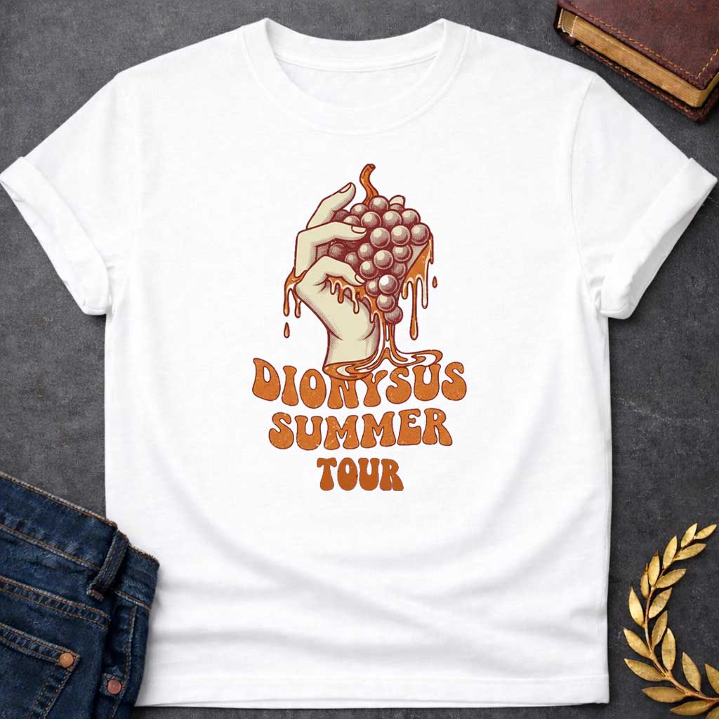 White T-shirt graphic featuring a vintage-style illustration of a hand squeezing a bunch of grapes with juice dripping down, rendered in a retro halftone print style in cream and burnt orange tones.  Bold groovy retro lettering below reads "Dionysus Summer Tour," inspired by 1970s rock concert merchandise design