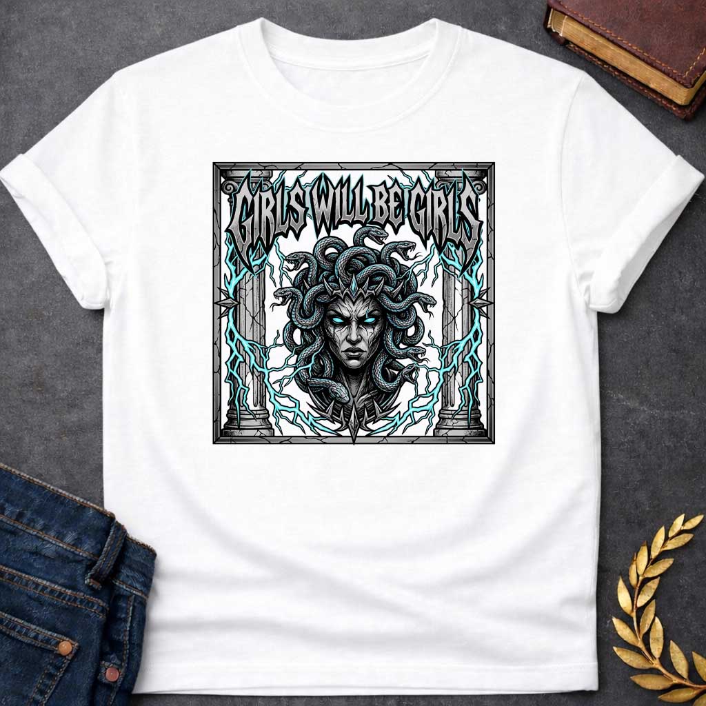 White T-shirt graphic in a dark heavy metal style featuring a fierce front-facing illustration of Medusa with glowing teal eyes, a spiked crown, and writhing snakes for hair, surrounded by electric teal lightning bolts and flanked by cracked stone Greek columns, all within a crumbling stone frame. Bold metallic gothic lettering across the top reads "Girls Will Be Girls,"