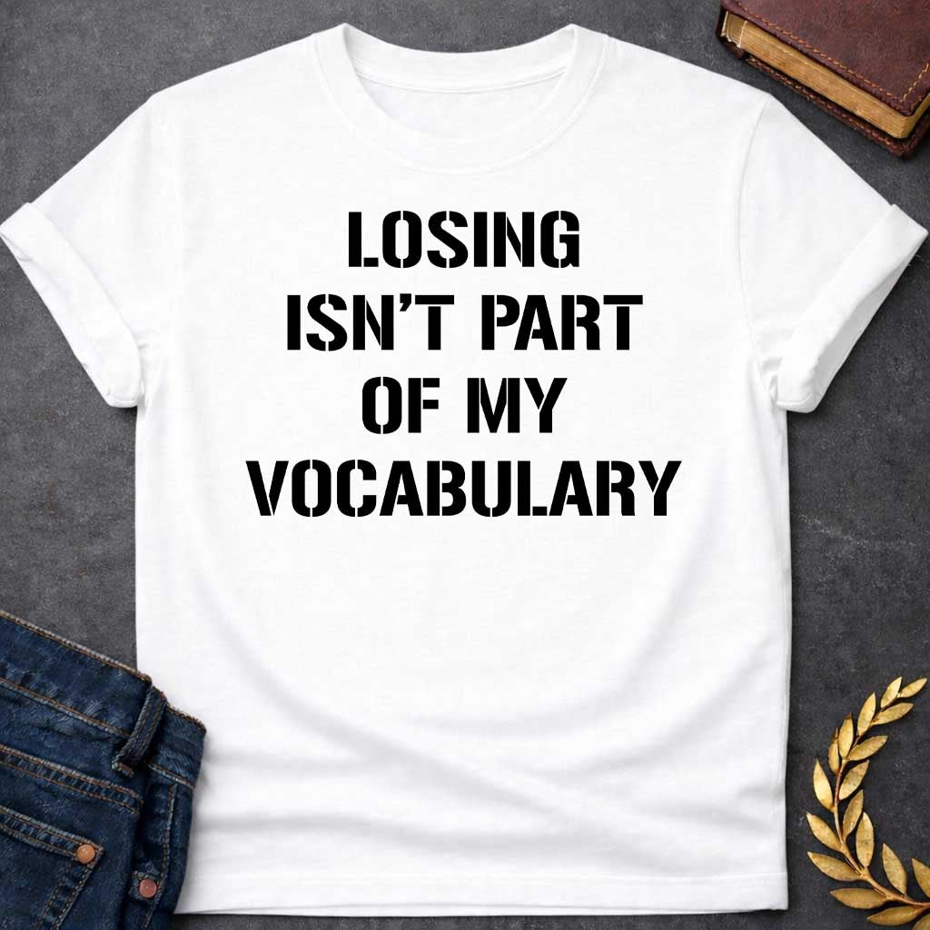 White Black T-shirt graphic in black featuring bold military stencil-style text reading "Losing Isn't Part of My Vocabulary" — a motivational phrase referencing Ares, the Greek God of War