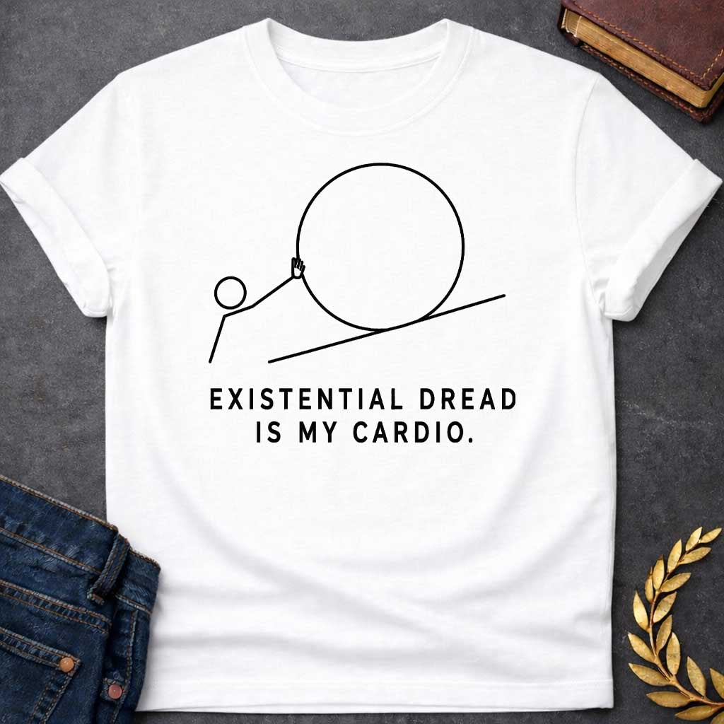 White T-Shirt with a minimalist black graphic design. It features a simple line-art illustration of a stick figure pushing a large circle up a diagonal line, depicting a humorous take on the myth of Sisyphus. Below the illustration, the black text reads: "EXISTENTIAL DREAD IS MY CARDIO."