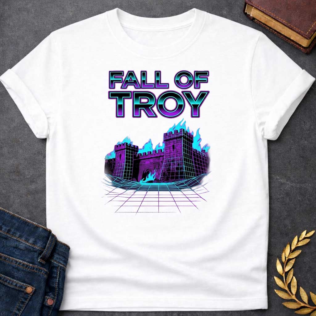 White T-shirt featuring bold chrome 3D outlined text reading "Fall of Troy" above a retro vaporwave-style illustration of the burning city of Troy depicted as a purple halftone castle engulfed in bright teal flames, set on a glowing teal perspective grid floor — referencing the legendary fall of Troy from Greek mythology, rendered in a vivid 1980s retro synthwave aesthetic in purple and teal tones
