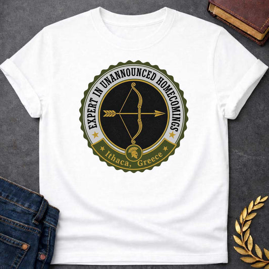 White T-shirt with a graphic featuring a vintage military challenge coin-style badge design in olive green, black, gold, and white. A golden bow and arrow are centered on a black background within the circular badge, with text arched around the outer ring reading "Expert in Unannounced Homecomings" flanked by gold stars. A green ribbon banner at the bottom features a Spartan helmet medallion and reads "Ithaca, Greece" with gold stars — a humorous reference to Odysseus, the hero of Homer's Odyssey who famous