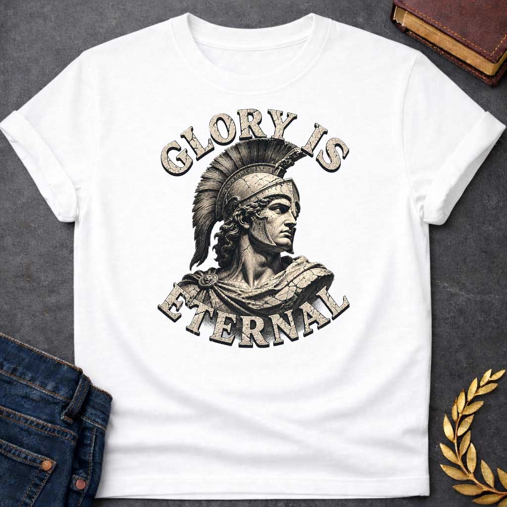 White T-Shirt with a classical illustration of a Greek warrior in profile, rendered in sepia tones with weathered, cracked texture. The figure wears an ornate Corinthian helmet with black horsehair crest, long curly hair, and armor with a draped cloak. The warrior gazes stoically with classical features. Distressed serif letters spell 'GLORY IS' above and 'ETERNAL' below. The design has a vintage, monumental quality reminiscent of ancient statuary, emphasizing themes of heroism, honor, and timeless legacy.