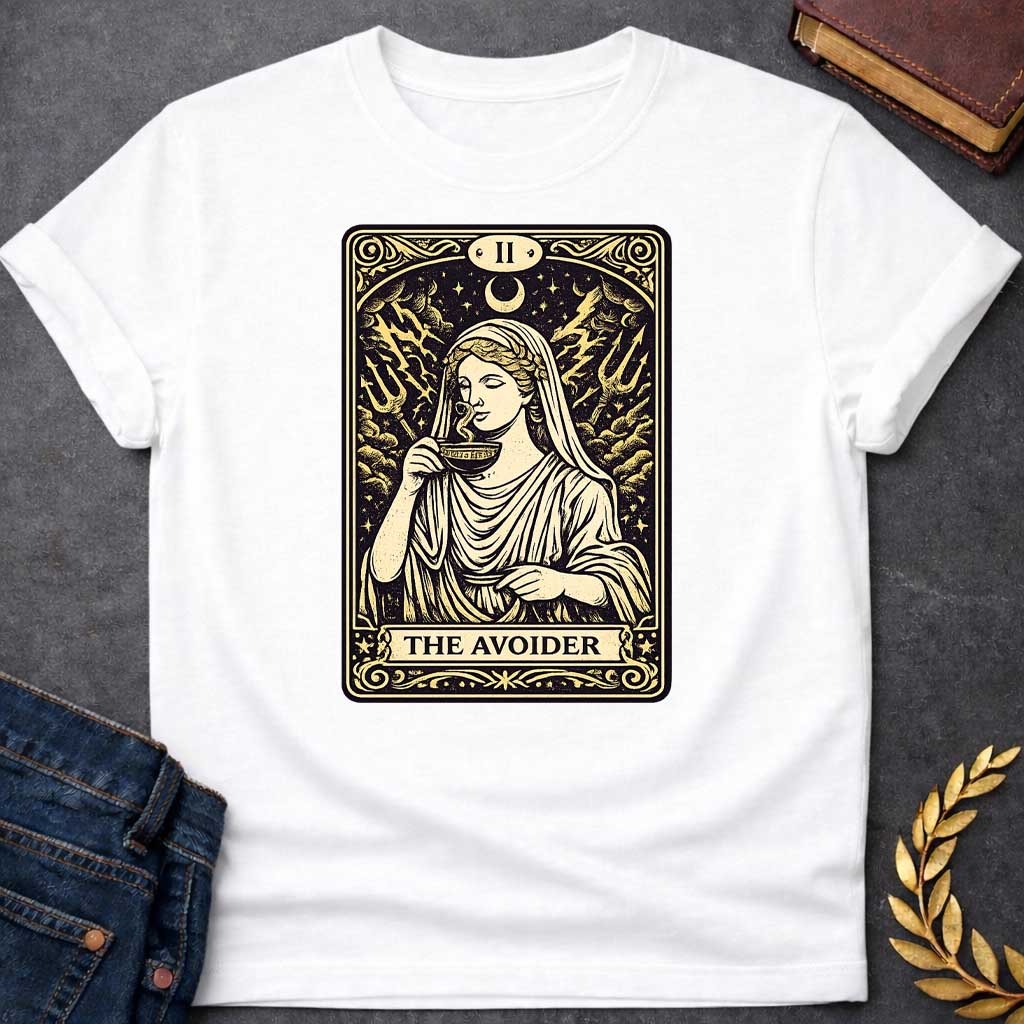 White T-shirt design in the style of a vintage tarot card. It features a woman in classical Greek robes calmly sipping from a cup. Behind her, lightning strikes and two tridents emerge from turbulent clouds under a crescent moon. The card is labeled with Roman numeral "II" at the top and the text "THE AVOIDER" in a banner at the bottom, all rendered in a cream and black woodcut aesthetic.