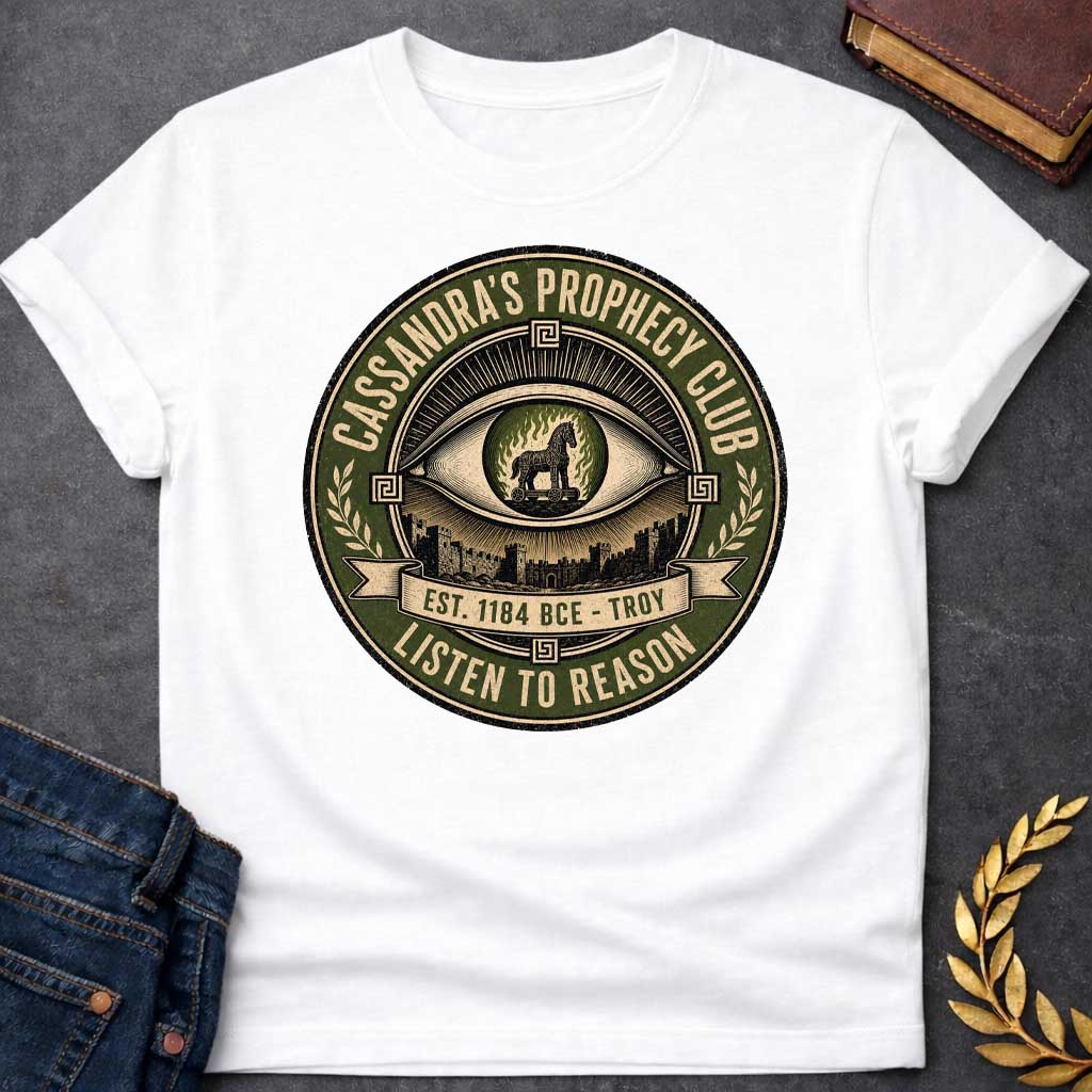 White T-shirt with a Vintage circular badge in olive green, cream, and black featuring an all-seeing eye at center with the Trojan Horse surrounded by flames in the pupil. Below the eye are the walls of Troy. Text reads 'CASSANDRA'S PROPHECY CLUB' around the top arc, 'EST. 1184 BCE - TROY' on a banner, and 'LISTEN TO REASON' along the bottom. Wheat sheaves and Greek key patterns decorate the sides. Distressed texture. References Cassandra's ignored warnings about the Trojan Horse.