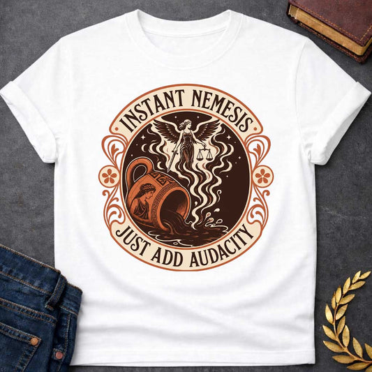 White T-shirt with a Vintage product-label style circular design in terracotta, cream, and dark brown. Text reads 'INSTANT NEMESIS' at top and 'JUST ADD AUDACITY' at bottom. Center features Nemesis, the winged Greek goddess of retribution, holding scales of justice above a spilling Greek vase with a classical Greek warrior profile. Swirling smoke rises from the vessel. Ornate Art Nouveau flourishes and floral medallions frame the design. Humorous take on Greek mythology and divine consequences.