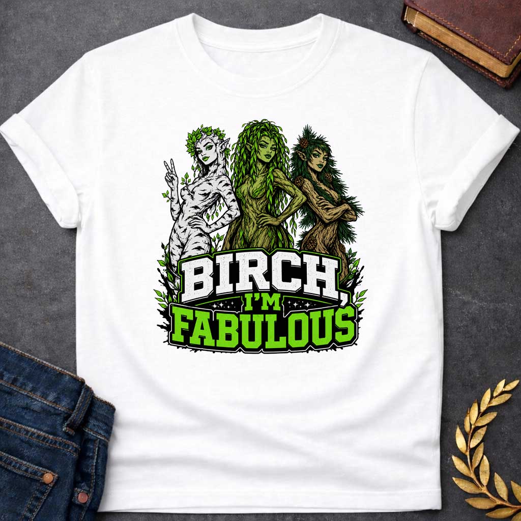 White T-shirt with a pun-based Greek mythology t-shirt design featuring a detailed engraving-style portrait of a hamadryad emerging from a birch trunk. She has long flowing hair, wears a floral wreath, and looks aside with a dramatic, sassy expression. Arched above her head is the bold black text "BIRCH, I'M FABULOUS" in a clean serif font. The entire graphic uses an elegant, fine-line black and white aesthetic