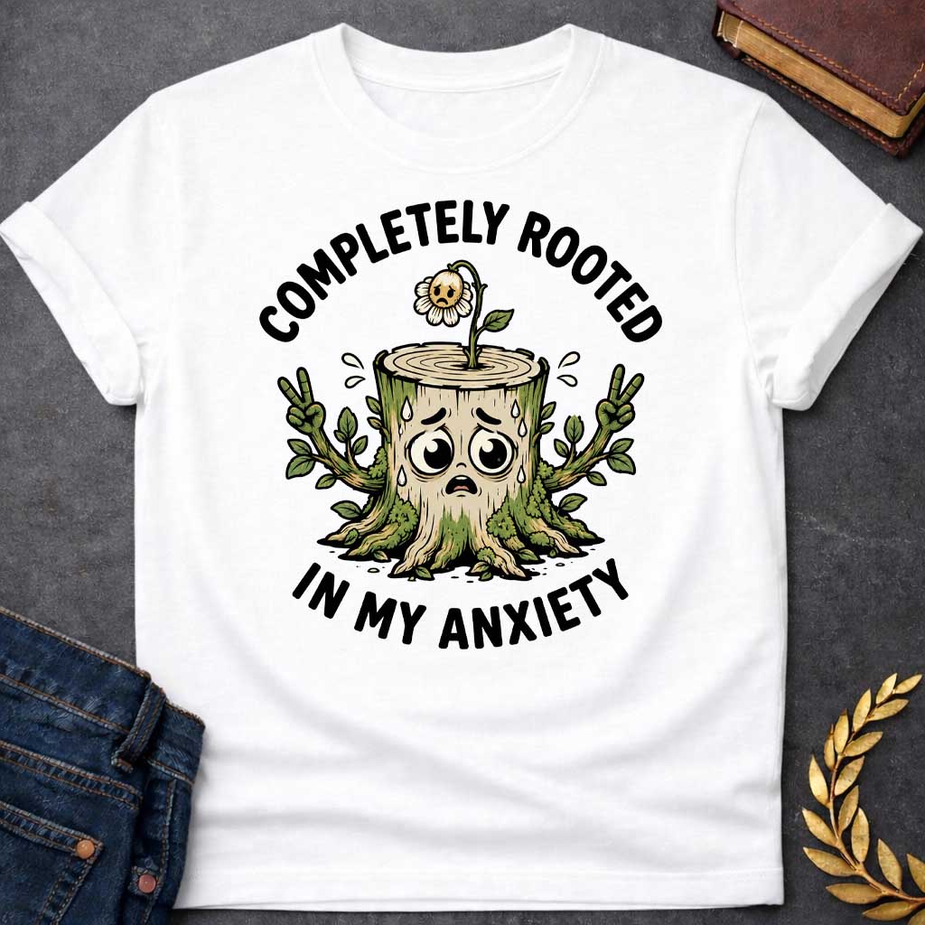 White T-shirt with a cottagecore-style Greek mythology t-shirt design featuring an engraving illustration of a dryad. The flowing hair intricately weaves into a robust network of tree roots below. Arched elegantly above the portrait is the text "COMPLETELY ROOTED" in a clean black serif font.