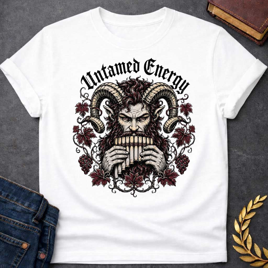 White T-shirt with a heavy metal style t-shirt graphic. It features a powerful, intense satyr or Pan figure with large, curling ram horns playing a pan flute. His fierce face is framed by a circular wreath of detailed, twisting grapevines, deep purple-red autumn leaves, and clusters of grapes. Arched directly above the illustration, the phrase "Untamed Energy" is written in a bold, black gothic font