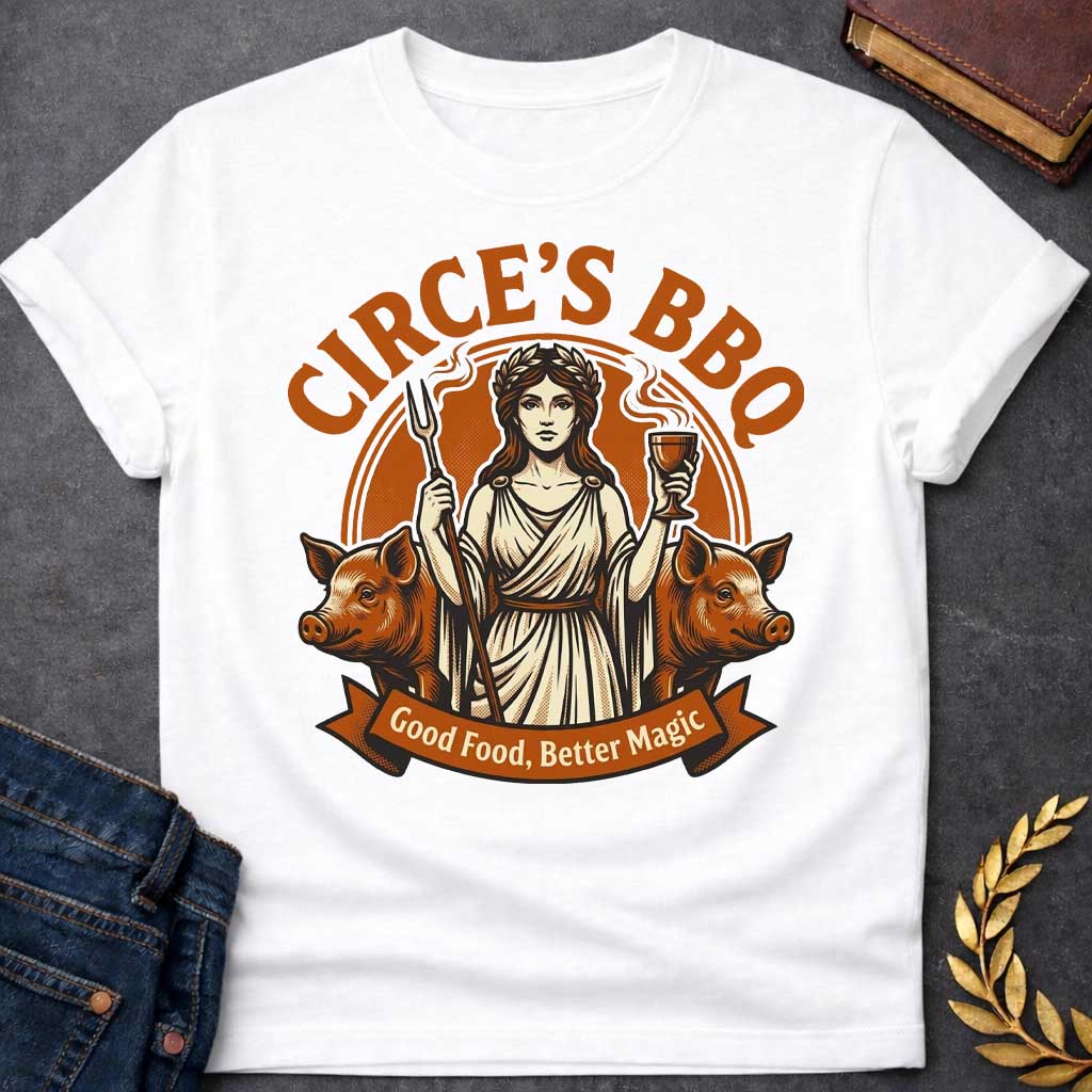 White T-shirt with a Humorous BBQ restaurant emblem featuring Circe from Greek mythology in classical robes. She holds a trident fork and wine goblet. Two pigs flank her sides, representing her legendary power to transform men through magic and enchantment. Brown and cream aesthetic. Text reads 'Circe's BBQ' and 'Good Food, Better Magic.' Clever wordplay merges ancient witchcraft with modern barbecue culture and humorous transformation themes.