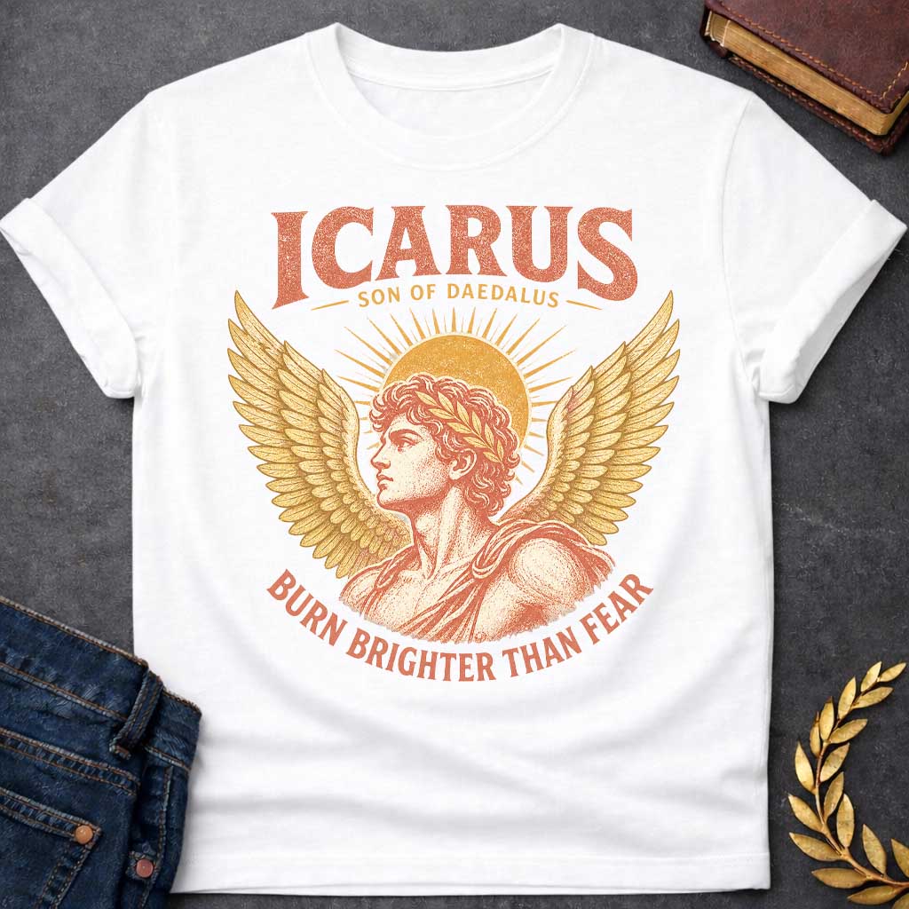 White t-shirt with a Vintage Icarus Greek mythology design featuring the son of Daedalus in profile with large golden wings, a laurel crown, and a radiant sun behind him. Distressed coral and gold artwork gives the design an antique classical look, with bold text reading “Icarus Son of Daedalus” and “Burn Brighter Than Fear.”