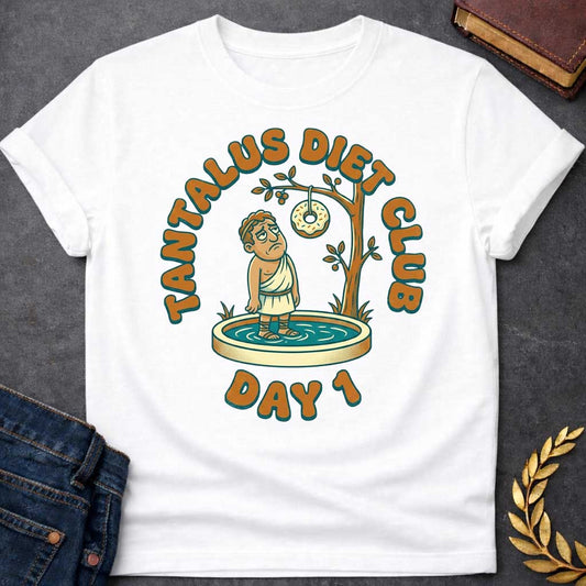 White t-shirt with A cartoon illustration, Standing in a small shallow pool next to a tree, a sad Greek man in a toga gazes glumly at a frosted donut with sprinkles dangling just out of reach from a branch. Chunky, retro orange and teal text arches over the graphic reading "TANTALUS DIET CLUB", with "DAY 1" featured prominently at the bottom.