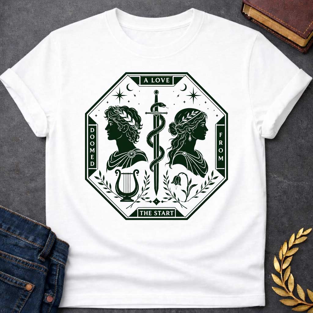 White t-shirt in dark green tarot-card style: an octagonal frame shows two facing silhouette profiles (a laurel-crowned man and a woman with a headband) separated by a snake-entwined sword. Below them sit a lyre and a drooping flower, framed by olive branches, stars, and crescent moons, evoking Orpheus and Eurydice.