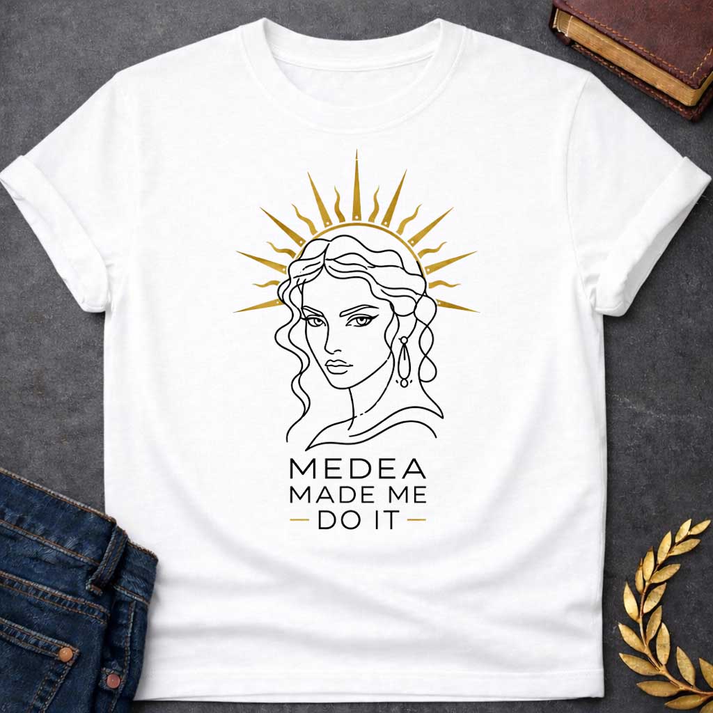 White T-shirt with a Minimalist line art portrait of Medea with wavy hair and drop earrings, framed by a golden radiating sun halo. Black and white design with gold accents. Text reads 'Medea Made Me Do It.' Humorous reference to blaming the legendary Greek sorceress for chaotic or destructive actions. Celebrates Medea's infamous power and magical influence with tongue-in-cheek blame attribution.