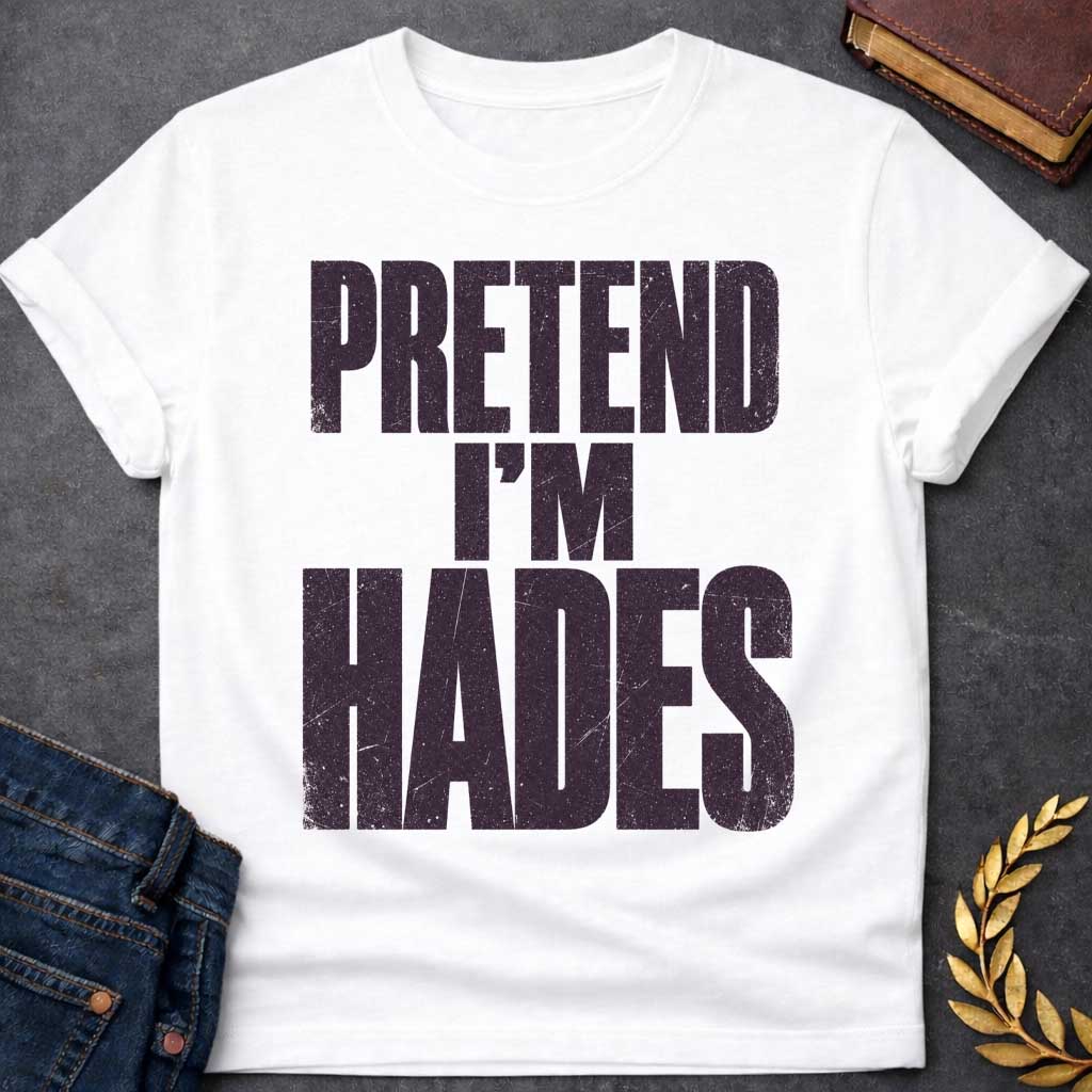 White t-shirt with a Pretend I’m Hades Greek mythology design featuring bold distressed dark purple typography on a transparent background. The stacked text reads “PRETEND I’M HADES” in a rugged vintage block font, creating a humorous design inspired by Hades, the Greek god of the underworld, the dead, and riches.