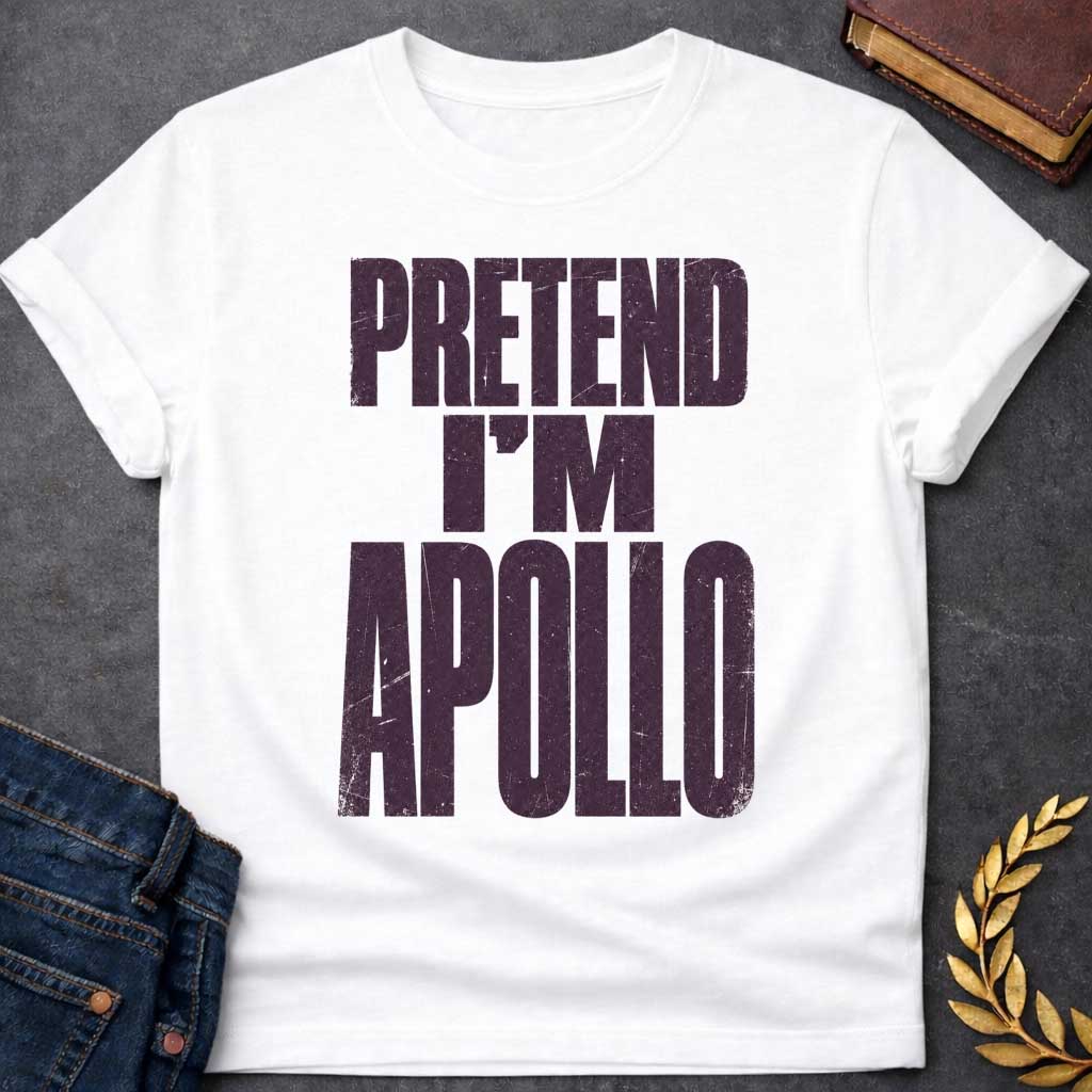White t-shirt with a Pretend I’m Apollo Greek mythology design featuring bold distressed purple typography on a transparent background. The stacked text reads “PRETEND I’M APOLLO” in a rugged vintage block font, creating a simple humorous design inspired by Apollo, the Greek god of the sun, music, poetry, prophecy, and healing.