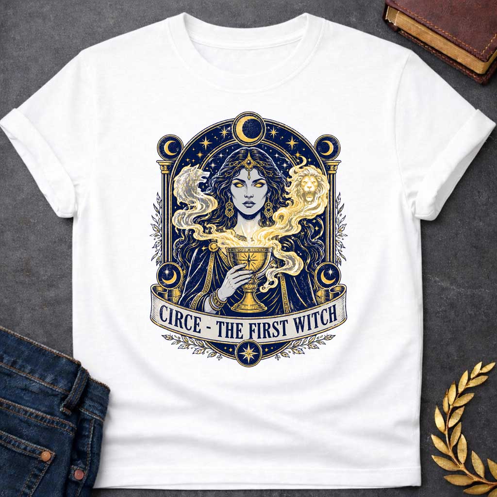 White T-shirt with a Mystical tarot-style portrait of Circe, the first witch from Greek mythology, rendered in navy blue and gold. She displays golden glowing eyes and magical hair infused with light energy. Twin lion heads flank her head symbolizing divine power. She holds an ornate golden goblet overflowing with luminous magic. Moon phases in crescent form circle her ethereal figure. Ornate architectural frame with columns and celestial decorations. Gold stars scatter throughout. Banner reads 'Circe - The