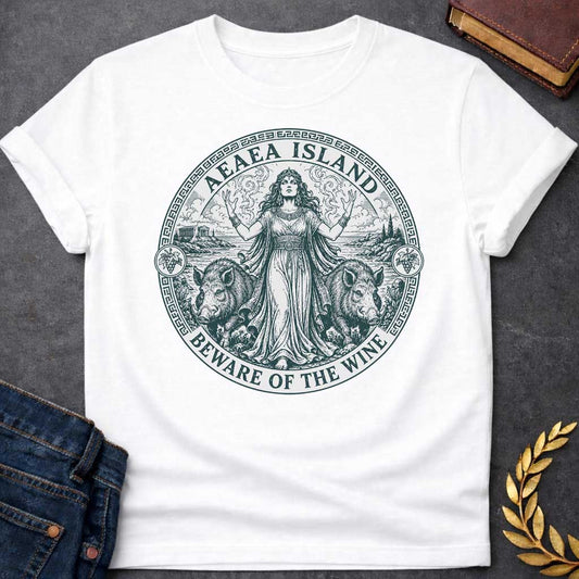 White T-shirt with a Classical engraving-style illustration of Circe, the Greek goddess of magic, commanding her island of Aeaea with raised arms and mystical power. She wears an ornate crown and flowing draped robes adorned with jewelry. Two human-headed pigs flank her, representing men transformed through her enchanted wine. Grape vines with fruit surround the mystical coastal scene. Greek key pattern border in teal frames the circular composition. Text reads 'Aeaea Island' and 'Beware of the Wine.' Celeb