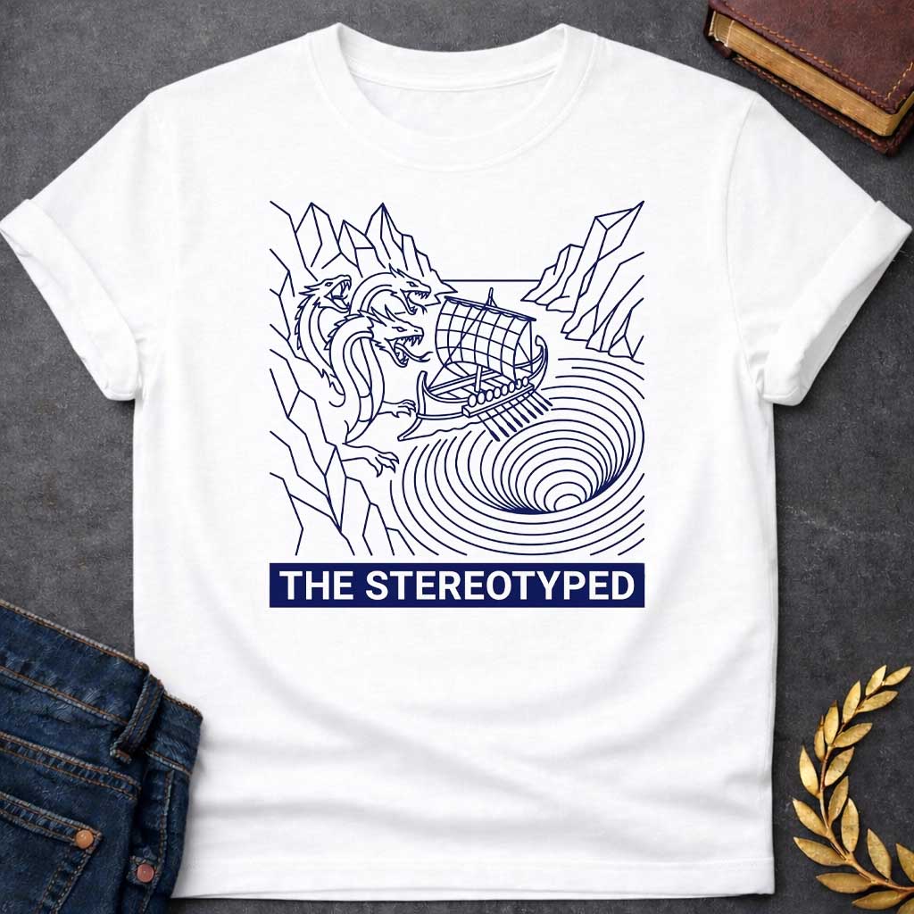 White t-shirt with A clean, line art t-shirt design. Rendered in dark blue line work, an ancient Greek galley ship navigates between a three-headed sea monster on jagged cliffs and a concentric, swirling whirlpool. Below the graphic, a solid dark blue rectangular banner features white, sans-serif block text that reads "THE STEREOTYPED".
