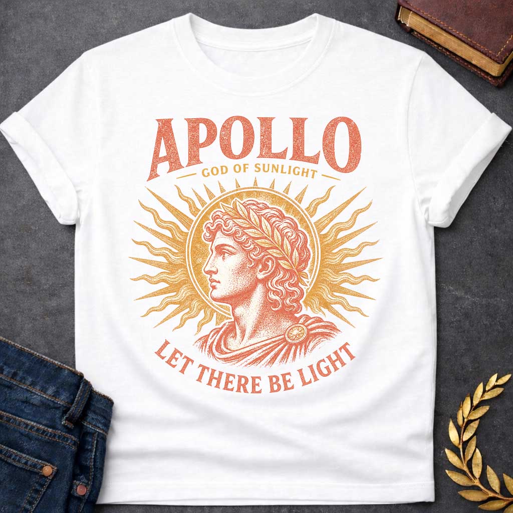 White t-shirt with a Vintage Greek mythology design featuring Apollo, god of sunlight, in a classical portrait wearing a laurel crown. A radiant golden sunburst frames the god in warm coral and gold engraving-style artwork. Bold text reads "Apollo – God of Sunlight" and "Let There Be Light," celebrating the legendary Olympian god.