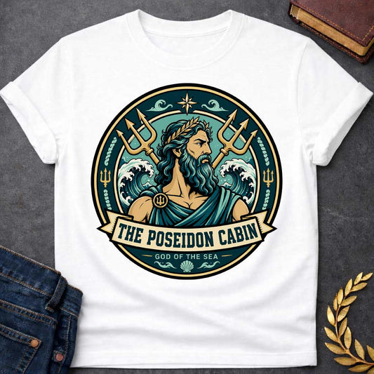 White t-shirt with a Poseidon Greek mythology cabin design featuring the bearded god of the sea with a golden laurel crown, crossed tridents, crashing ocean waves, and nautical symbols. Teal, aqua, gold, and black circular camp-style emblem includes the text “The Poseidon Cabin” and “God of the Sea.”