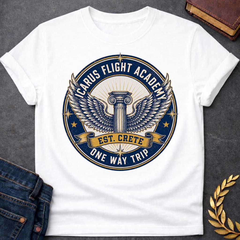 White t-shirt A circular, distressed vintage emblem design. At the center of a cream circle, a classic Greek Ionic column sprouts a large pair of detailed, spreading wings. A dark blue outer ring features the text "ICARUS FLIGHT ACADEMY" at the top and "ONE WAY TRIP" at the bottom. A golden banner across the center reads "EST. CRETE," adding a dark humor twist to the mythological flight.