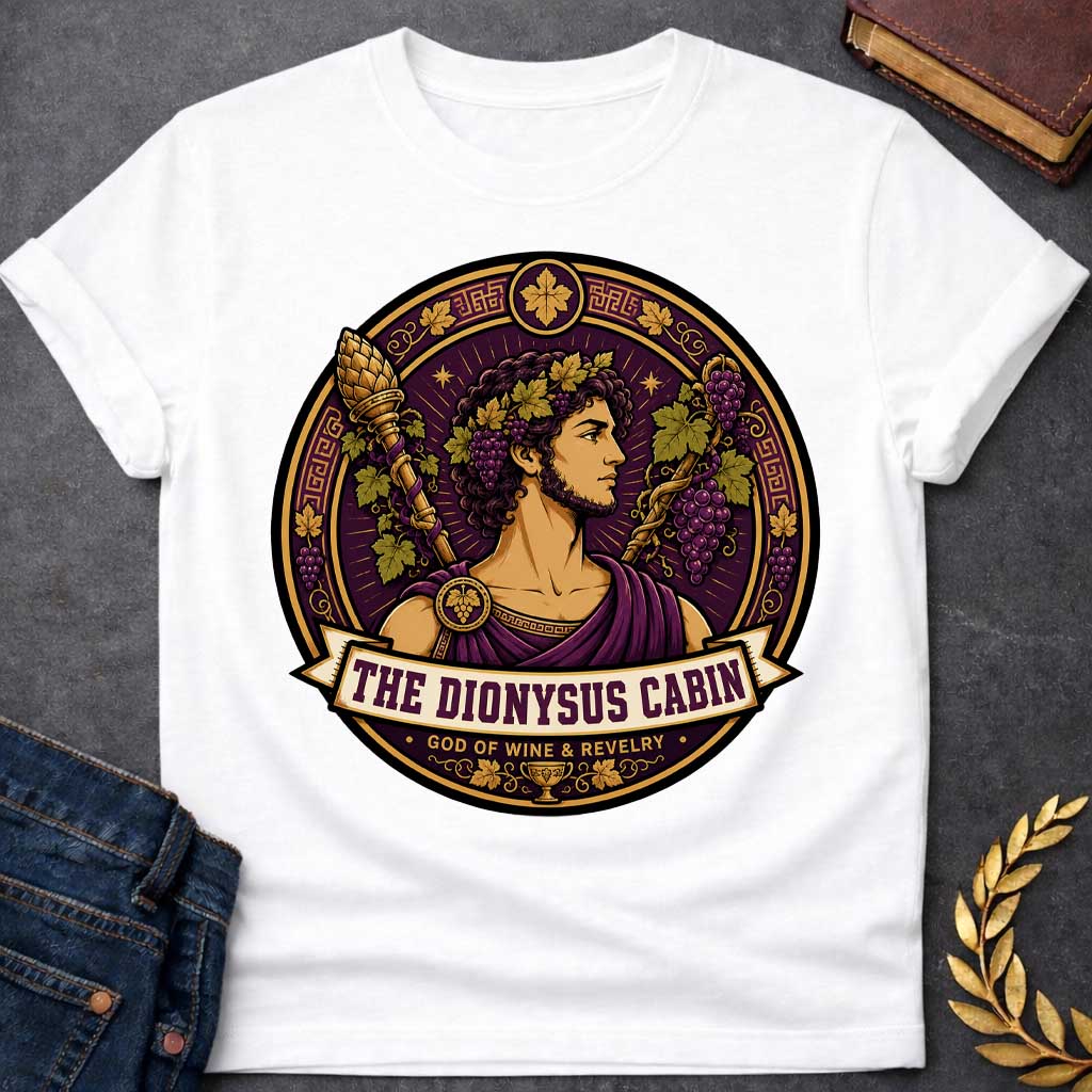 White t-shirt with a Dionysus Greek mythology cabin design featuring the god of wine and revelry wearing a grapevine crown and purple robes, surrounded by clusters of grapes, vine leaves, a thyrsus, Greek key patterns, and a wine cup. Purple and gold circular emblem includes the text “The Dionysus Cabin” and “God of Wine & Revelry,”