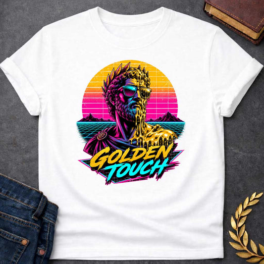White t-shirt with A Retro synthwave-inspired Greek mythology design featuring a stylized bust of King Midas wearing sunglasses as molten gold drips over half his face and shoulder. A vibrant neon sunset, grid landscape, and mountains create an 80s vaporwave backdrop. Bold brush lettering reads "Golden Touch" in gold and teal, using bright pink, purple, cyan, and gold for a striking vintage aesthetic.