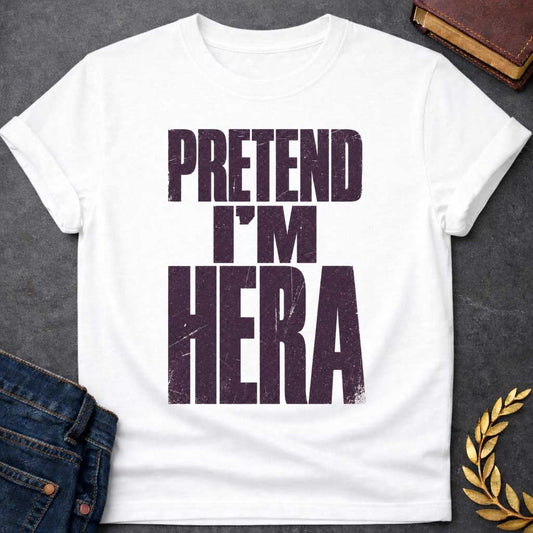 White t-shirt with a Pretend I’m Hera Greek mythology design featuring bold distressed dark purple typography on a transparent background. The stacked text reads “PRETEND I’M HERA” in a rugged vintage block font, creating a humorous design inspired by Hera, the Greek goddess of marriage, women, family, and queen of the Olympian gods.