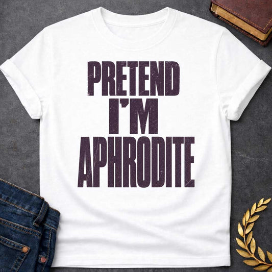 White t-shirt with a Pretend I’m Aphrodite Greek mythology design featuring bold distressed purple typography on a transparent background. The stacked text reads “PRETEND I’M APHRODITE” in a rugged vintage block font, creating a simple humorous design inspired by Aphrodite, the Greek goddess of love and beauty.
